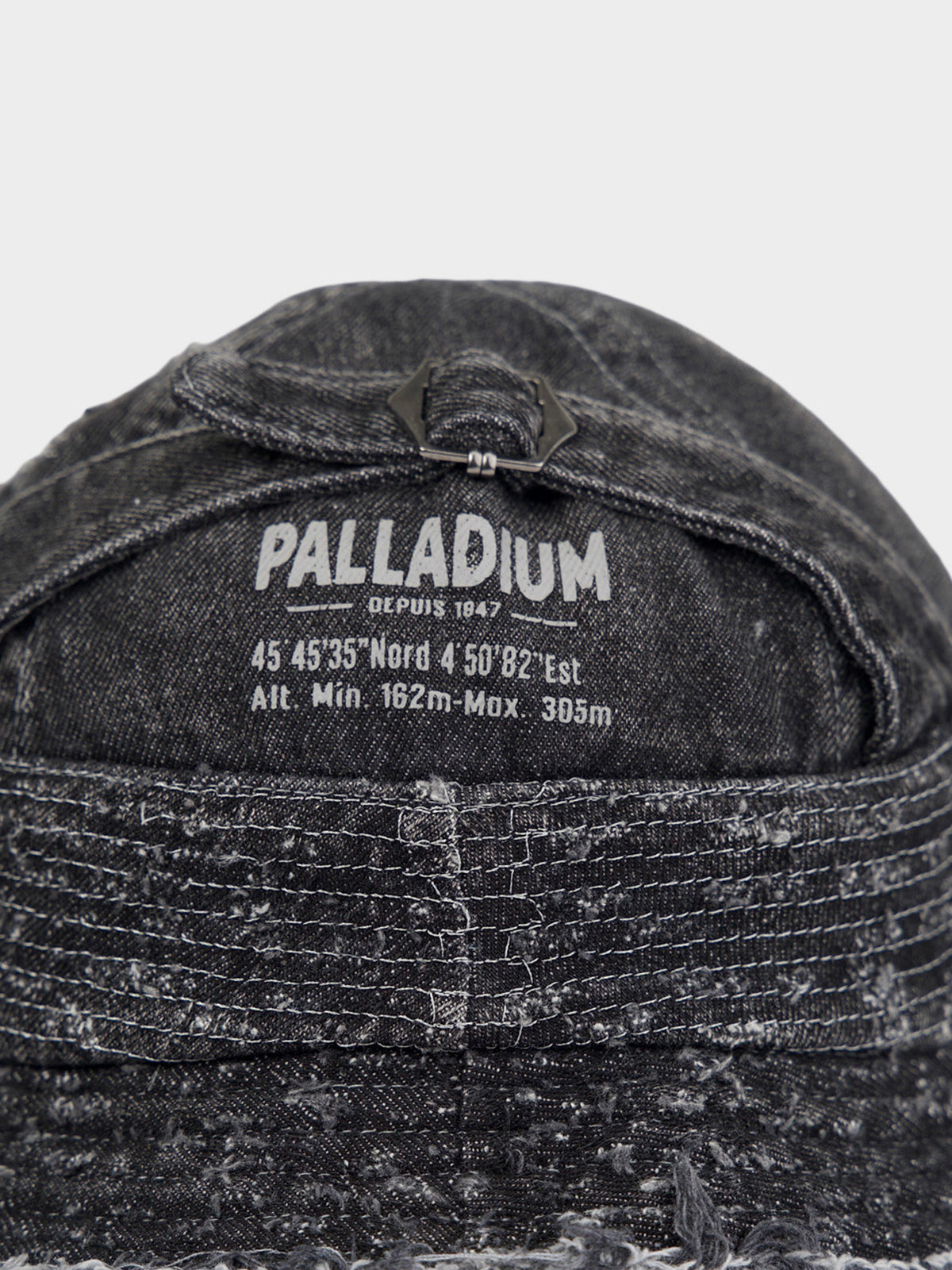 Palladium Frayed Bucket Hat in Black - back detail view with adjustable buckle and Palladium branding